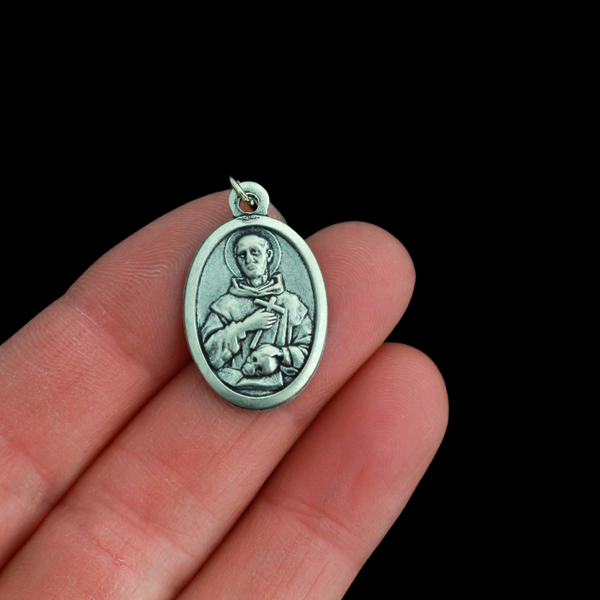 Saint Bruno of Cologne medal that depicts the saint with a skull on the front and is marked "Pray For Us" on the back