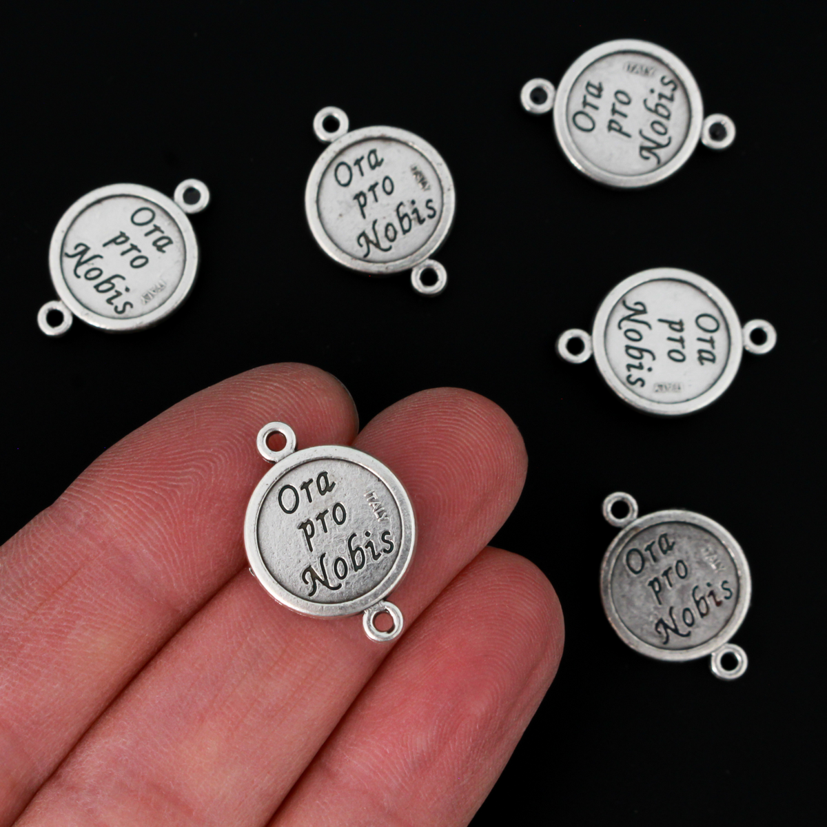 Saint Joseph round flat connector links that are silver oxidized plating on a base metal. The backside is marked "Ora Pro Nobis" in Latin which translates to pray for us
