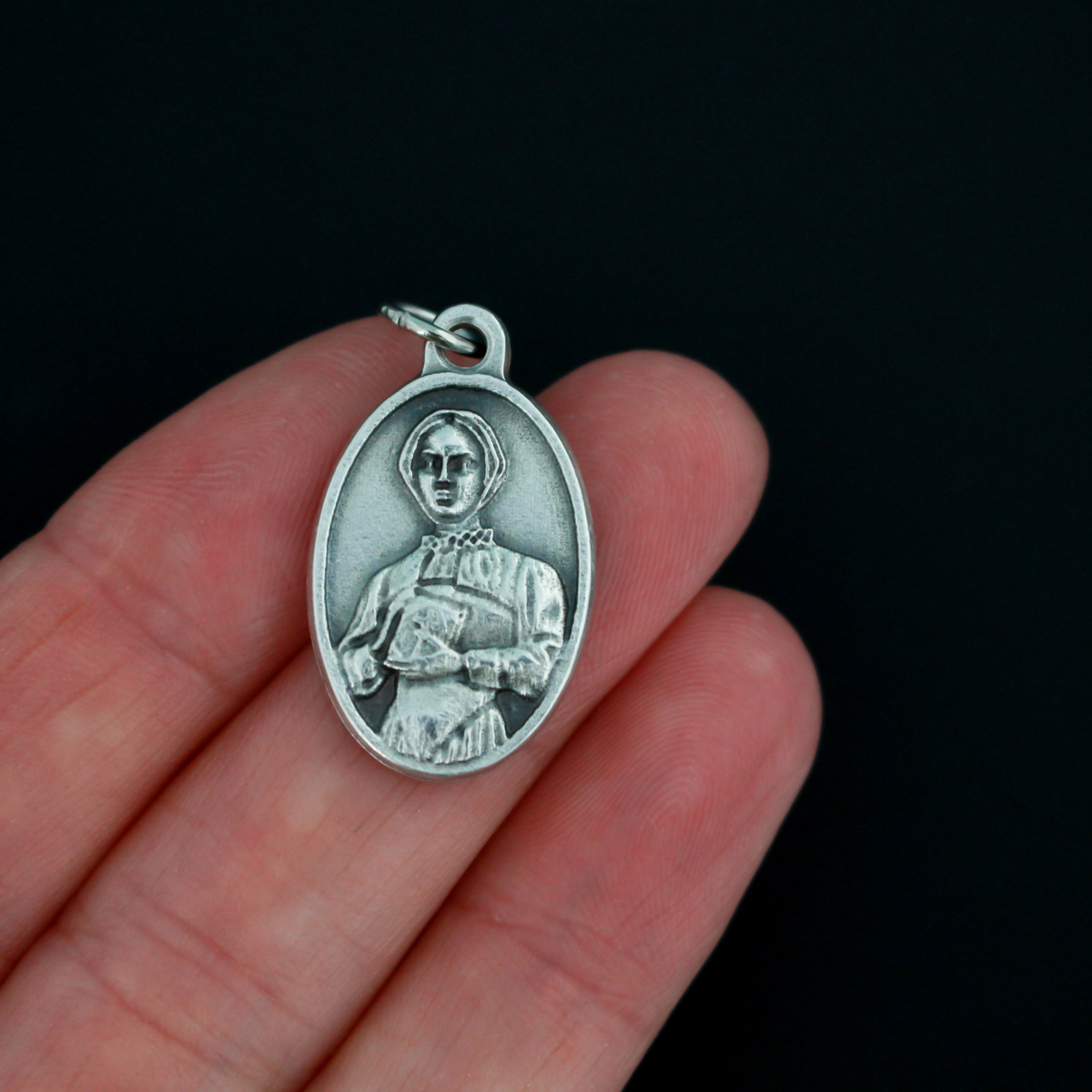 Saint Margaret Clitherow medal that depicts the saint on the front and is marked "Pray For Us" on the back
