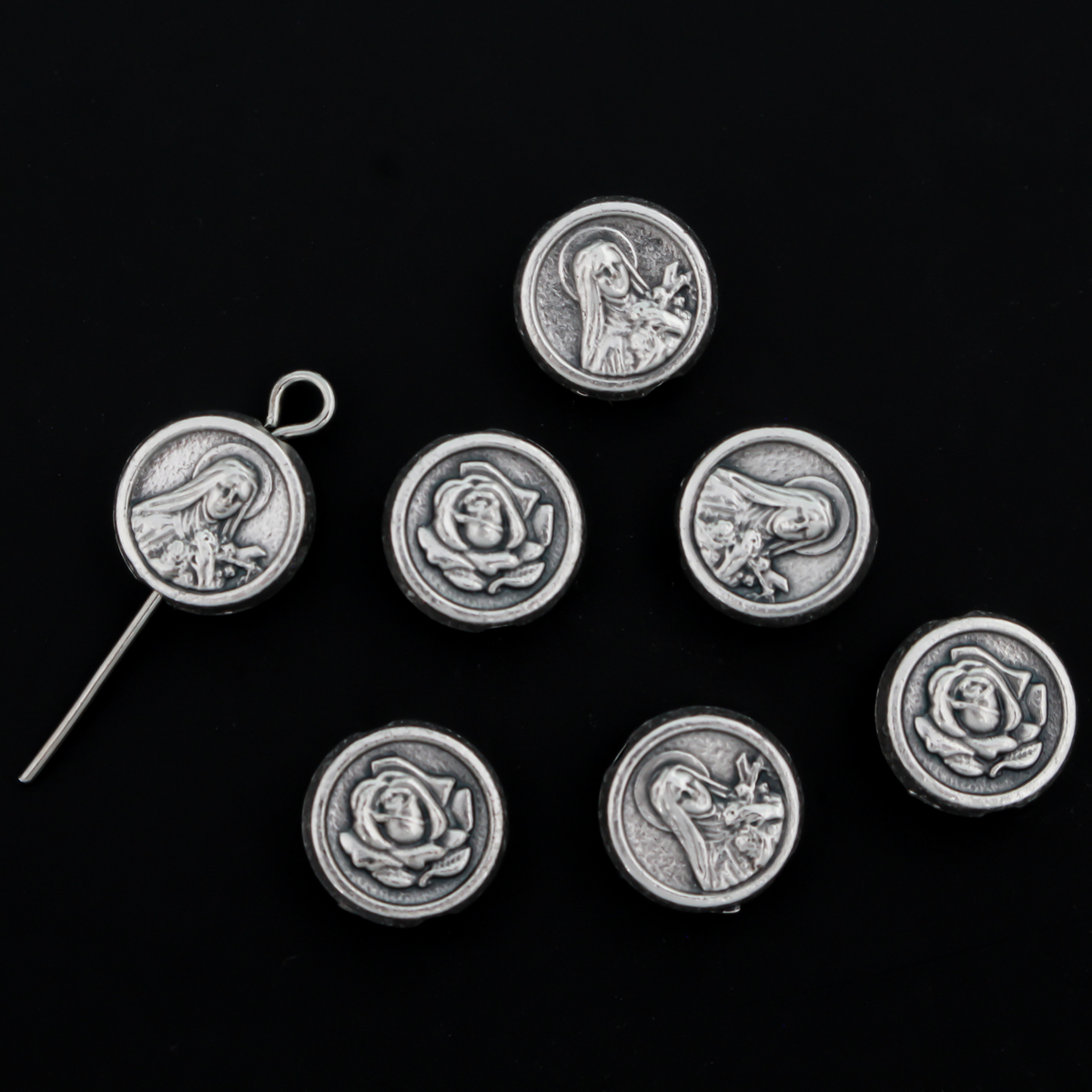 St. Therese of Lisieux metal beads with a rose on the backside. These round, flat beads are silver oxidized base metal and are handcrafted in Italy