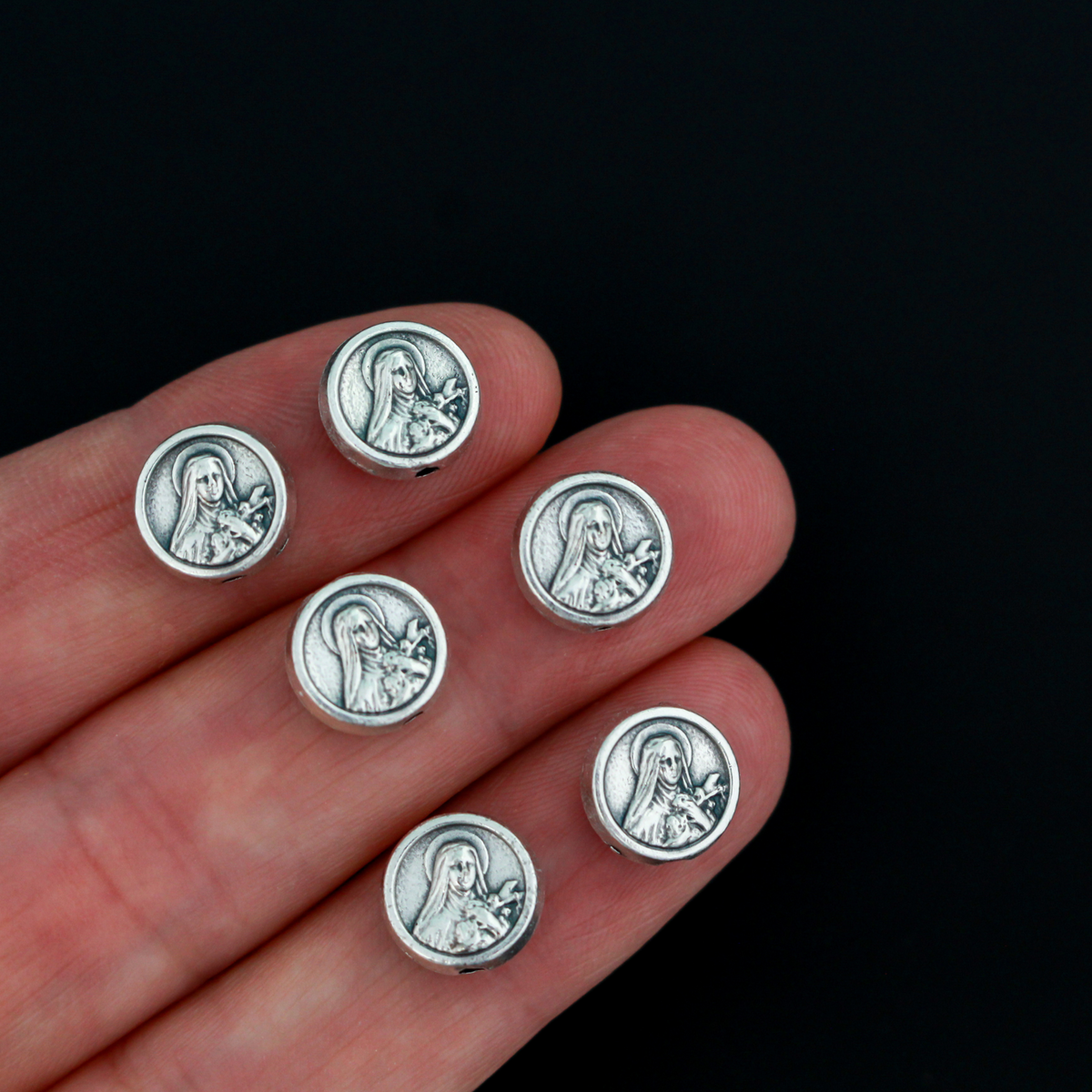 St. Therese of Lisieux metal beads with a rose on the backside. These round, flat beads are silver oxidized base metal and are handcrafted in Italy