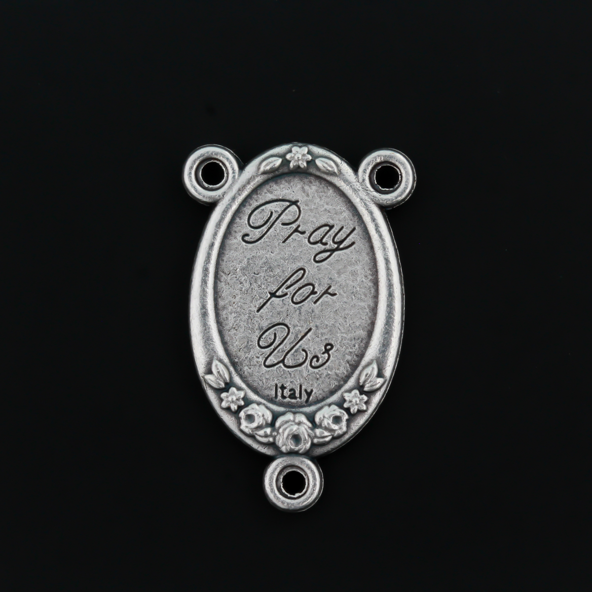 Rosary center that has a color image of Saint Therese of Lisieux inlaid in a silver oxidized Center with a flower detail on the edge