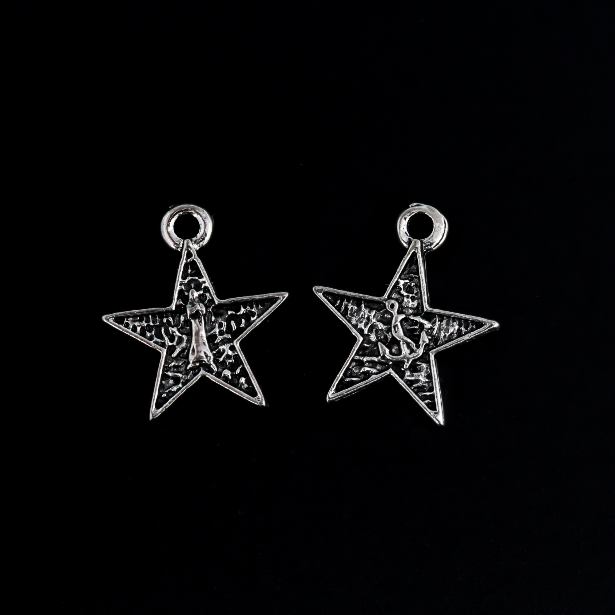Small star-shaped charms that feature The Blessed Virgin Mary as Our Lady of the Sea on the front side and an anchor on the backside.