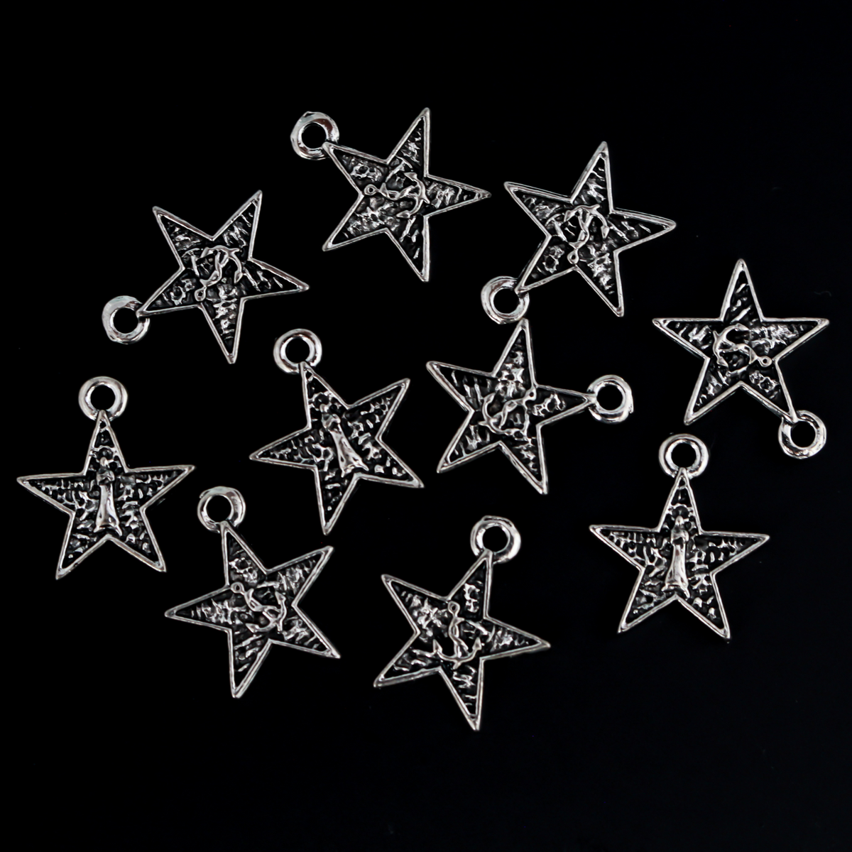 Small star-shaped charms that feature The Blessed Virgin Mary as Our Lady of the Sea on the front side and an anchor on the backside.