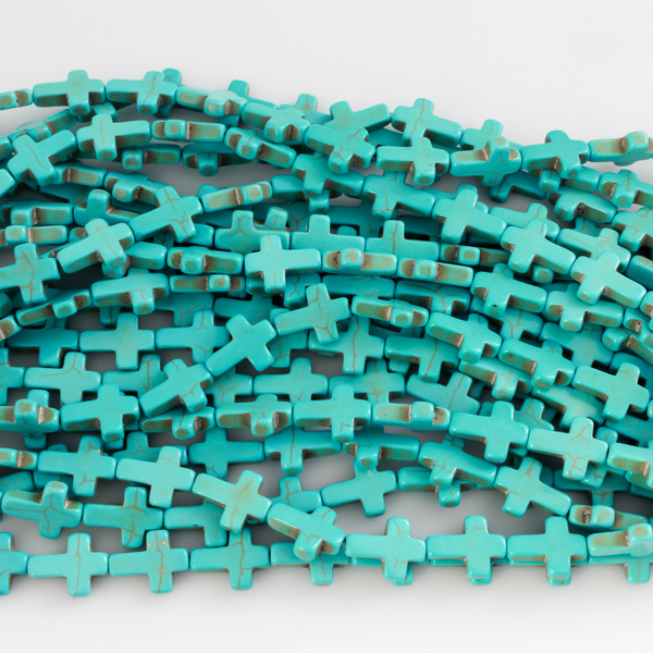 Cross shaped beads that are a synthetic turquoise material called howlite, each cross is 16x12mm
