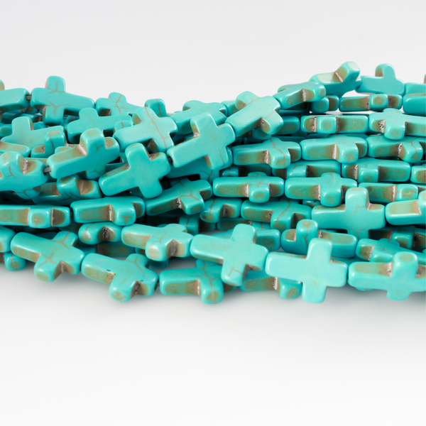 Cross shaped beads that are a synthetic turquoise material called howlite, each cross is 16x12mm
