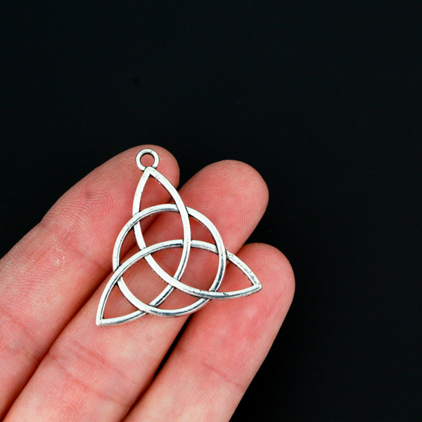 Celtic knot charms that are an antiqued silver tone color, 28.5mm long