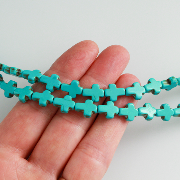 Turquoise cross shaped beads that are a synthetic turquoise material, 10x8x3mm