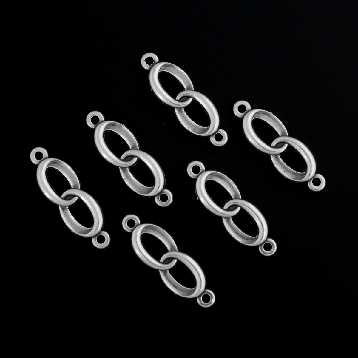 Connector links that are intertwined wedding rings in an antique silver color.