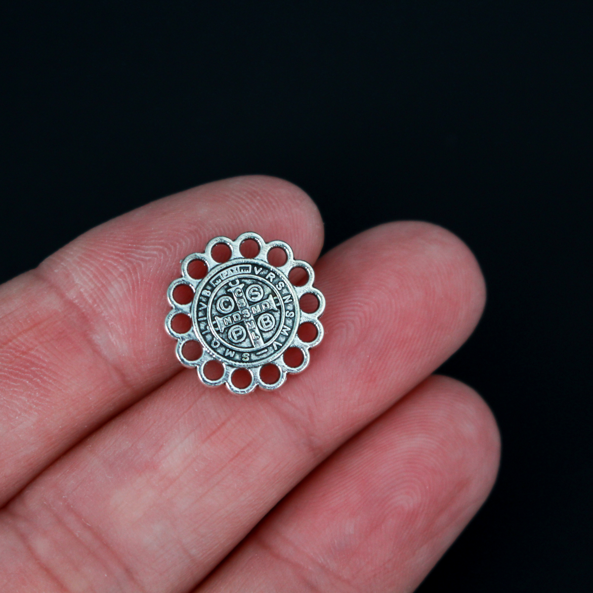 15mm St. Benedict charms. The edge of the charm is made up of circles so you can use this as a charm, a rosary centerpiece, bracelet links, etc