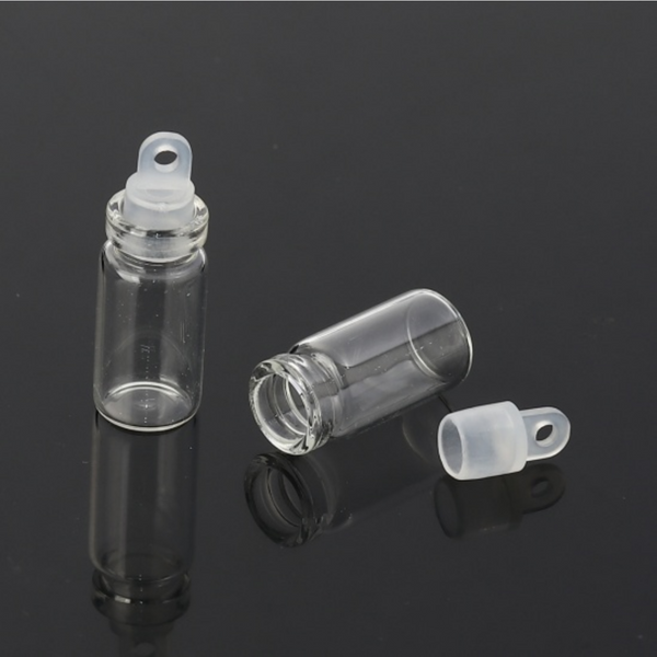 small glass bottle with a plastic stopper that has a bail hole so you can easily attach a jump ring (not included)
