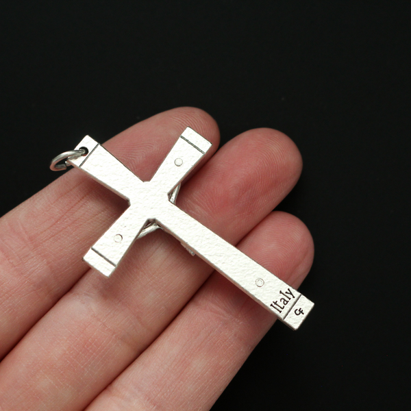 Simple traditional cross that has a textured design and an angel on each end of the cross beam facing Jesus 2" long
