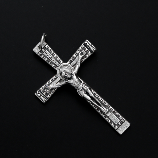 Simple traditional cross that has a textured design and an angel on each end of the cross beam facing Jesus 2" long