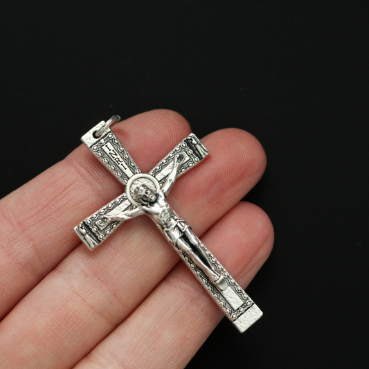 Simple traditional cross that has a textured design and an angel on each end of the cross beam facing Jesus 2" long