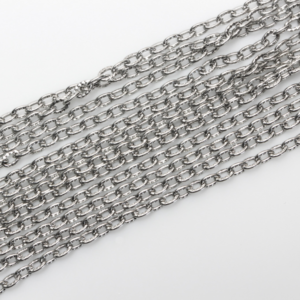 Iron cable chain that has unsoldered links that are flat and oval in shape with a textured design, three meters in length