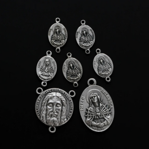 The Five Holy Wounds of Christ devotional chaplet set. This set consists of seven medals in total.