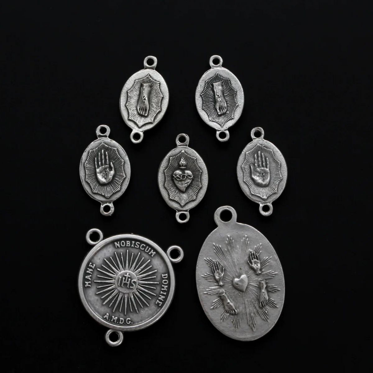 The Five Holy Wounds of Christ devotional chaplet set. This set consists of seven medals in total.