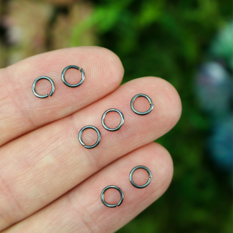 5mm gunmetal gray jump rings made from an iron-based alloy.