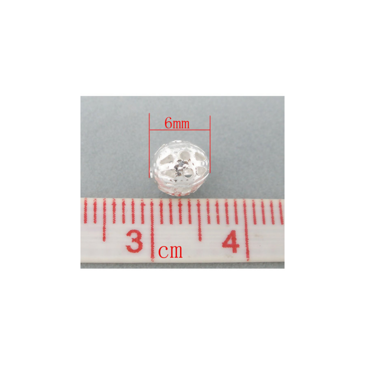 6mm lightweight metal beads that are hollow with a cutout (filigree) design and a shiny platinum silver color