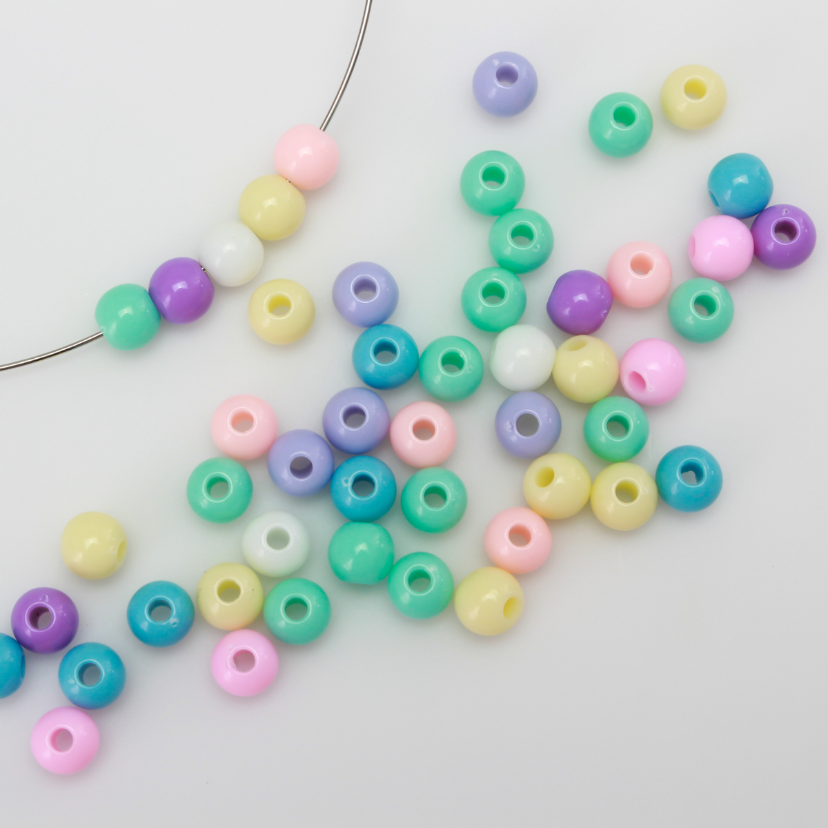 6mm round opaque beads in a random mix of pastel colors.