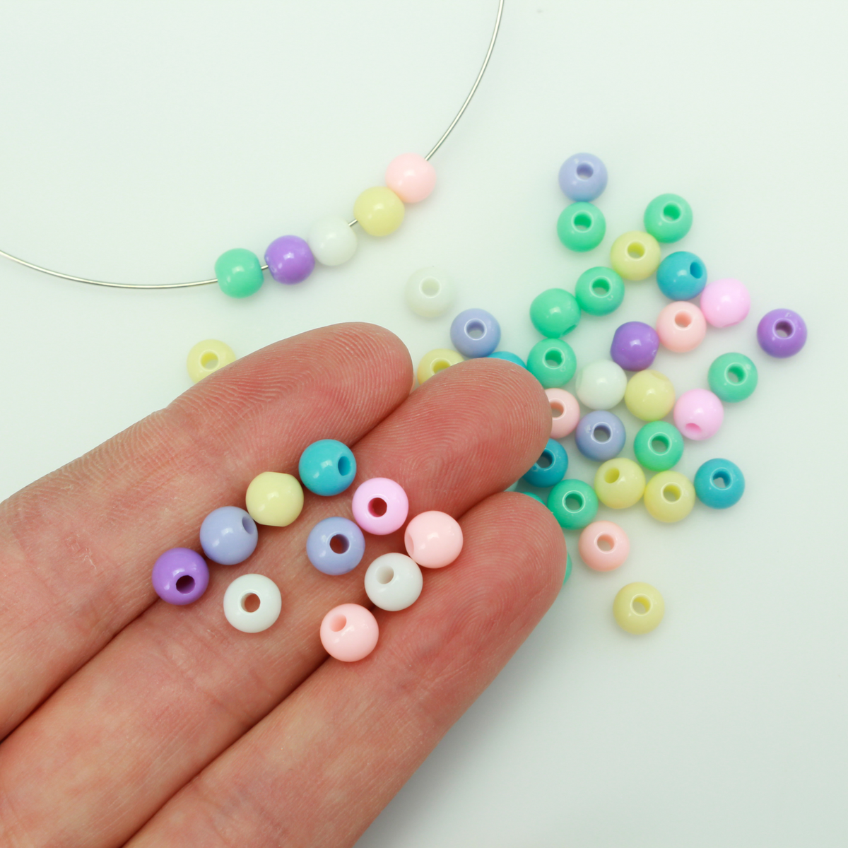6mm round opaque beads in a random mix of pastel colors.