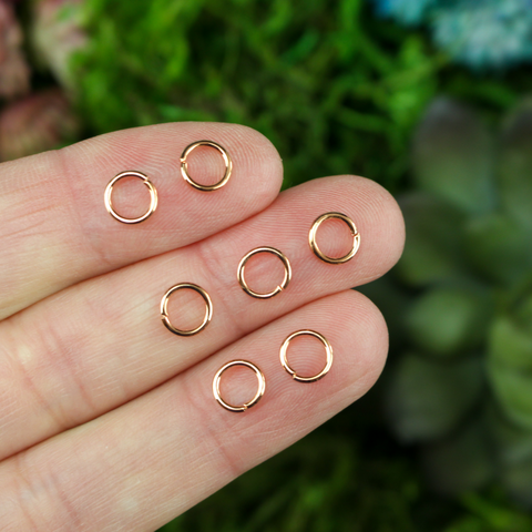 6mm round rose gold colored jump rings sold in packs of 100 pieces