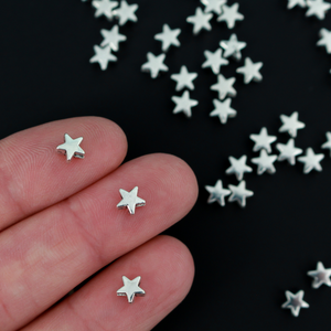 Tiny silver-tone metal beads shaped like five pointed stars, perfect for rosaries, chaplets, bracelets. 6mmx6mm