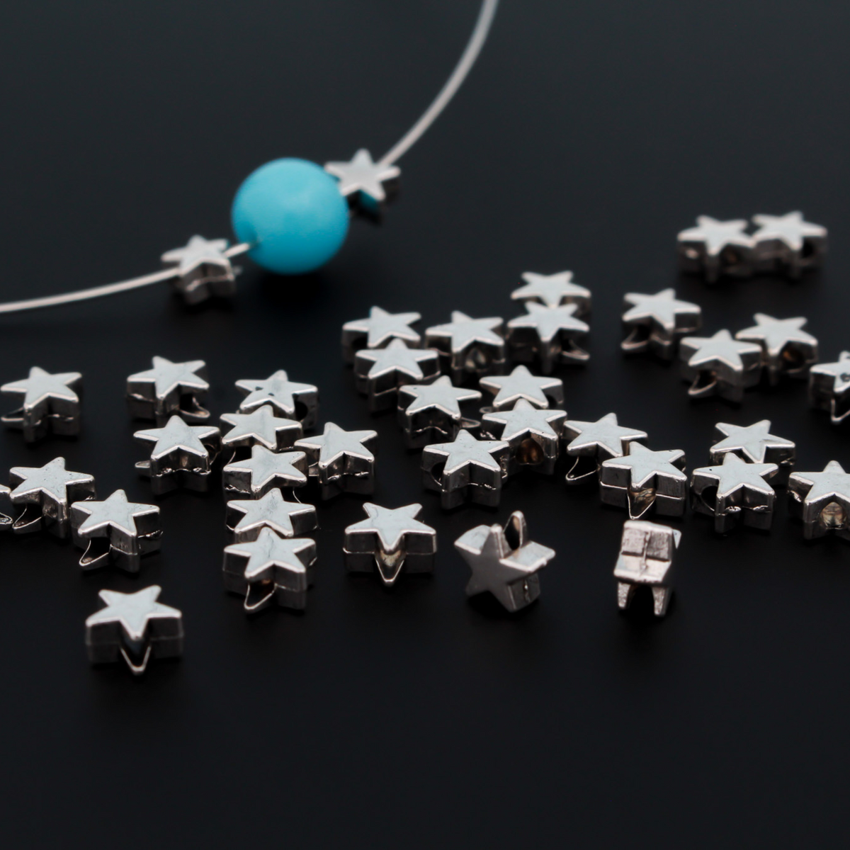Tiny silver-tone metal beads shaped like five pointed stars, perfect for rosaries, chaplets, bracelets. 6mmx6mm