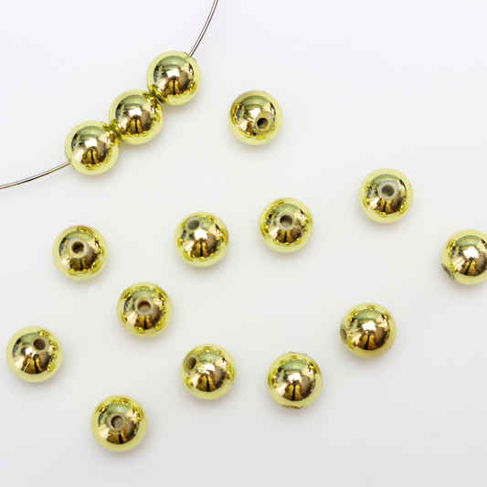 8mm round plastic beads with a gold metallic plating. 