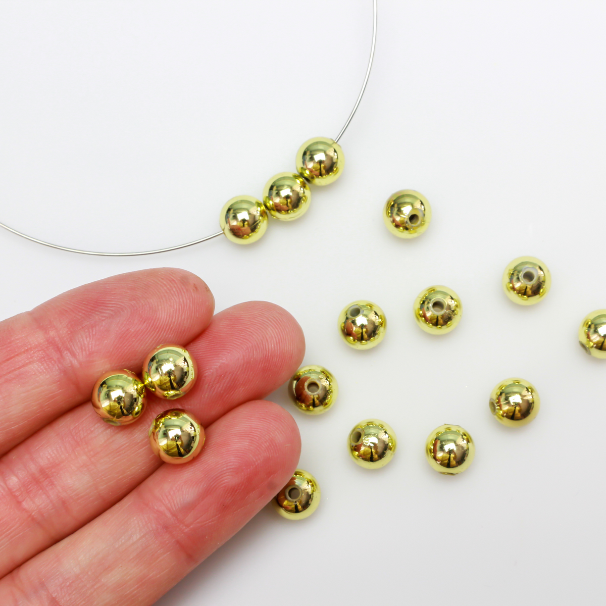 8mm round plastic beads with a gold metallic plating. 