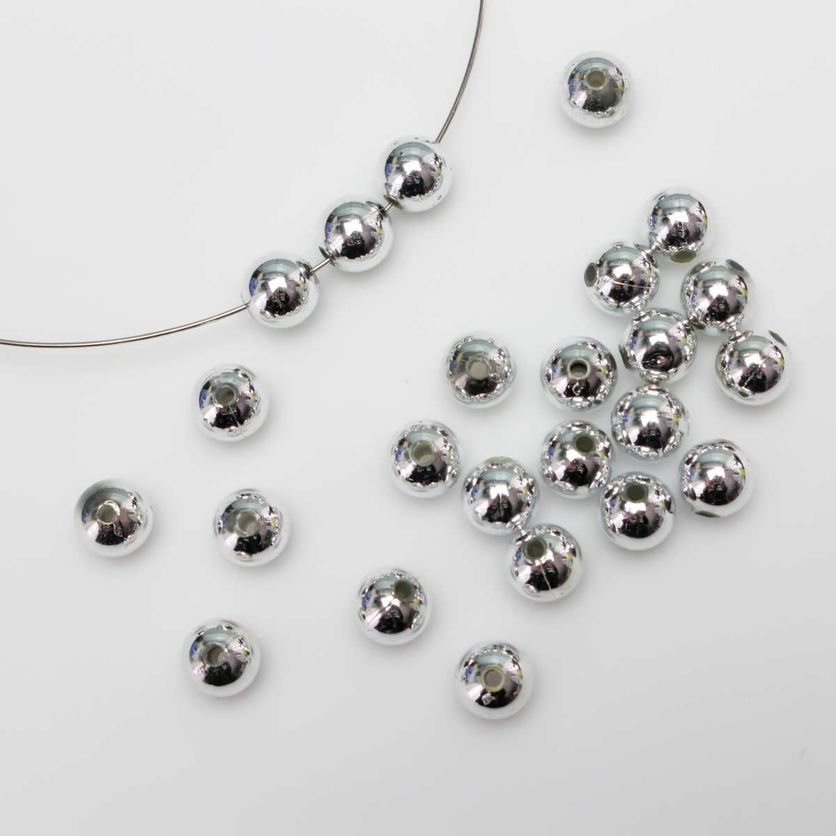 8mm round plastic beads with a shiny silver metallic plating. 
