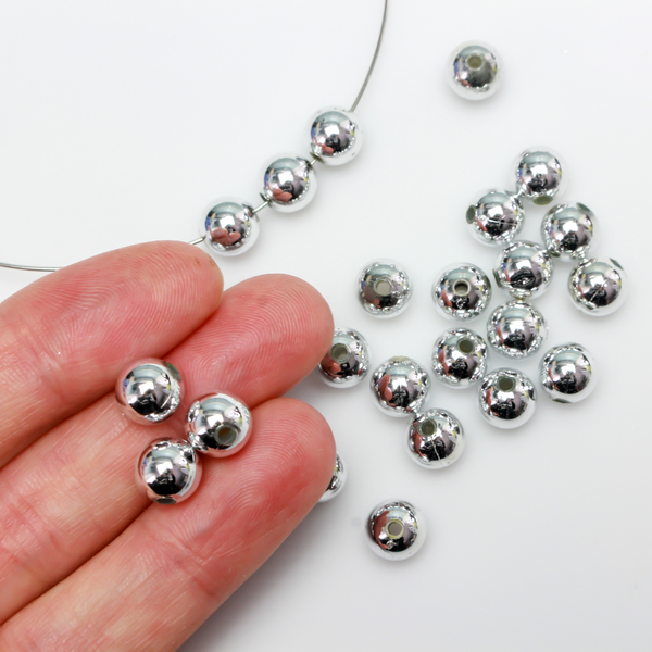8mm round plastic beads with a shiny silver metallic plating. 