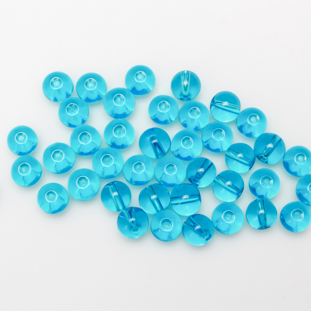 8mm round glass beads in a transparent aquamarine blue color.