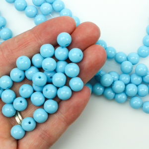 Smooth round glass beads in a baby blue color, 8mm round