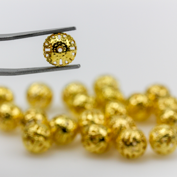 8mm round lightweight metal beads that are hollow with a cutout (filigree) design and a shiny gold finish