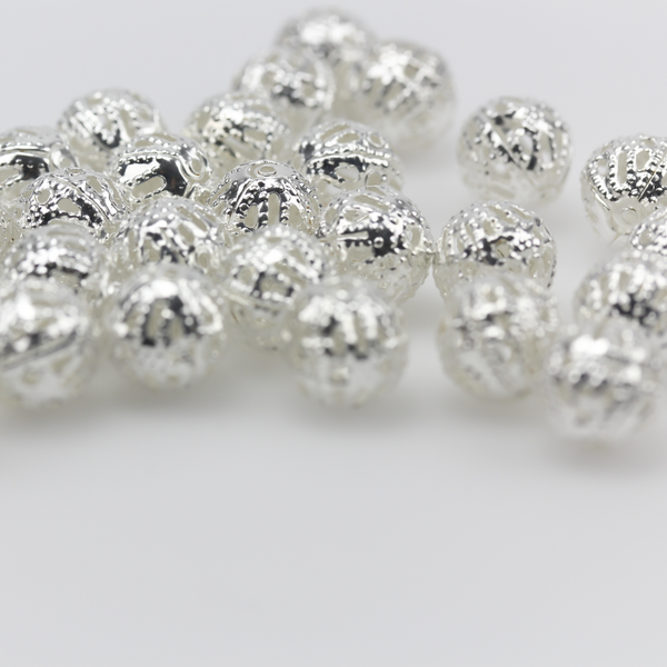 6mm lightweight metal beads that are hollow with a cutout (filigree) design and a shiny platinum silver color