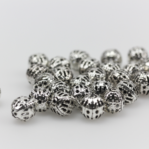 6mm lightweight metal beads are hollow with a cutout filigree design and an antiqued silver color