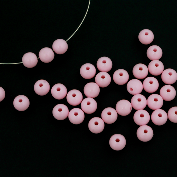 Round pale pink opaque beads that are 8mm in diameter with a 1.5mm hole size.