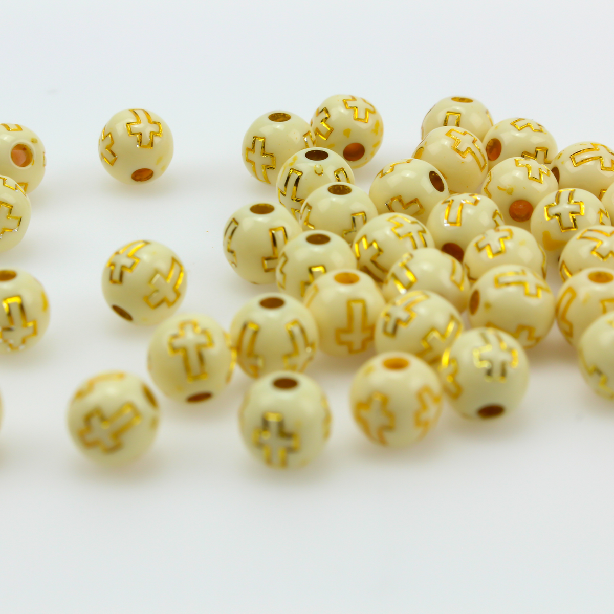 Beige (off-white) acrylic beads with a metallic gold etched cross design. The beads are 8mm round with a 2mm hole size