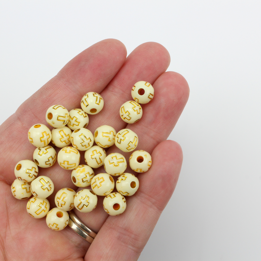 Beige (off-white) acrylic beads with a metallic gold etched cross design. The beads are 8mm round with a 2mm hole size