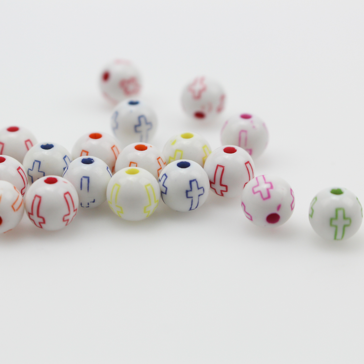 White acrylic beads with an etched cross design in beautiful vibrant colors