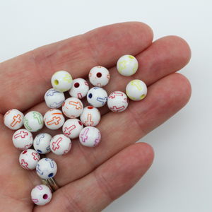 White acrylic beads with an etched cross design in beautiful vibrant colors