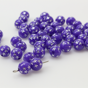 8mm round purple opaque beads that have a silver star design etched into them. 