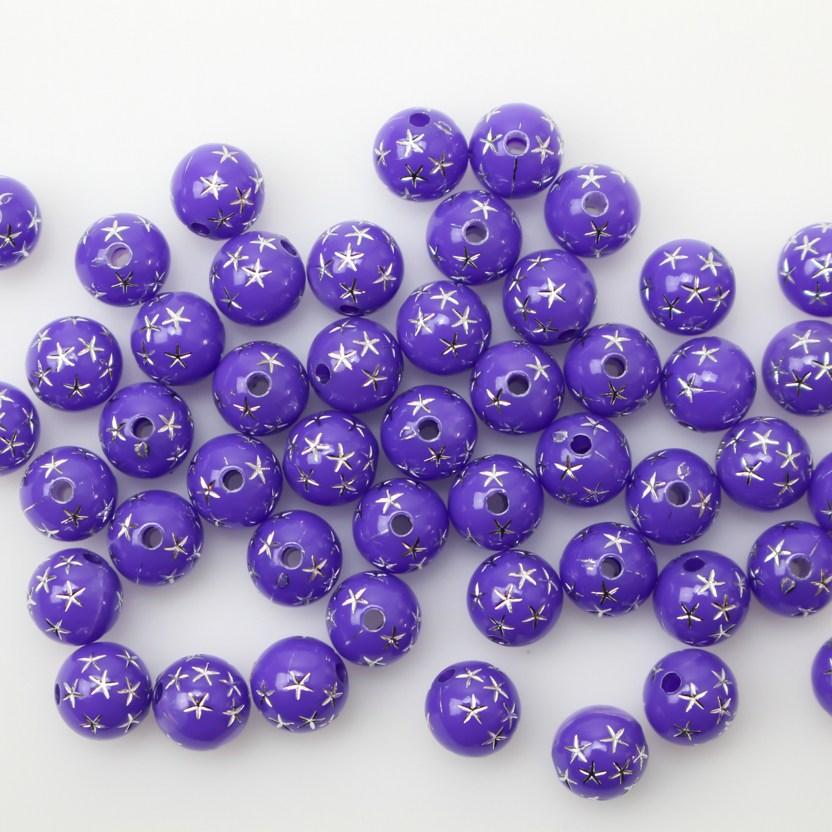 8mm round purple opaque beads that have a silver star design etched into them. 