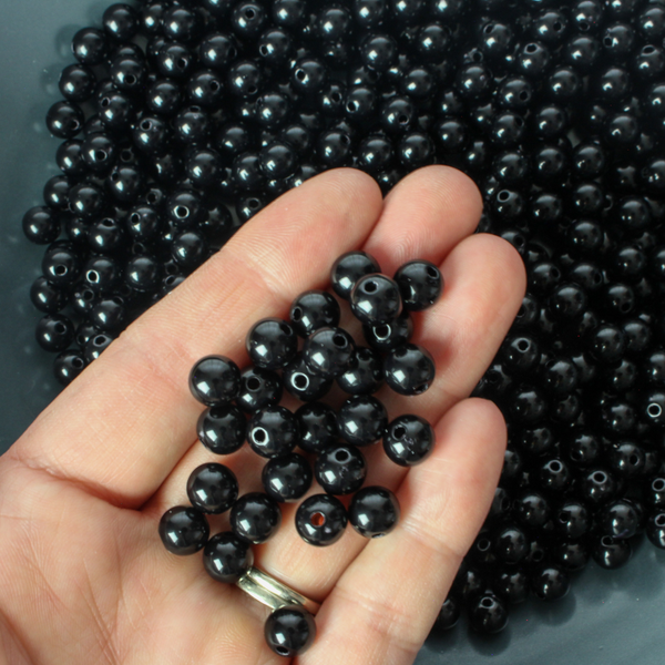Round black opaque beads that are 8mm in diameter with a 1.5mm hole size