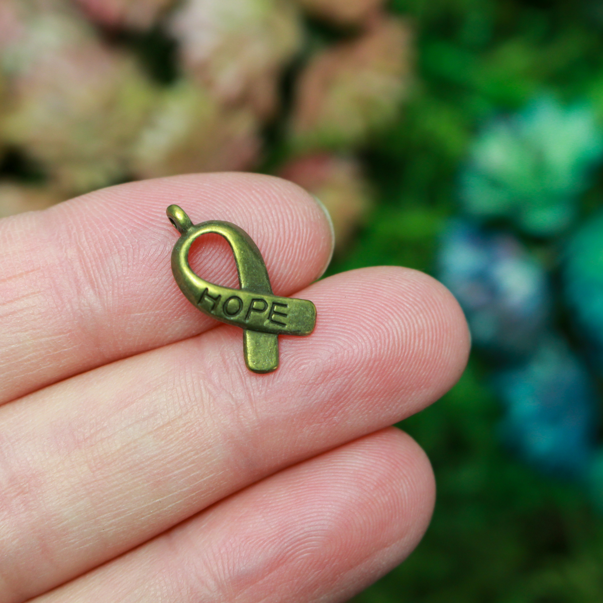 Bronze awareness ribbon charms with the word "HOPE" engraved on the ribbon, 18mm long