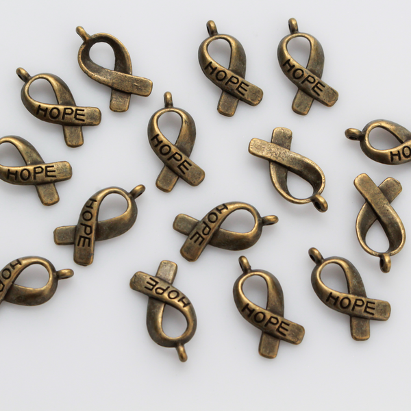 Bronze awareness ribbon charms with the word "HOPE" engraved on the ribbon, 18mm long