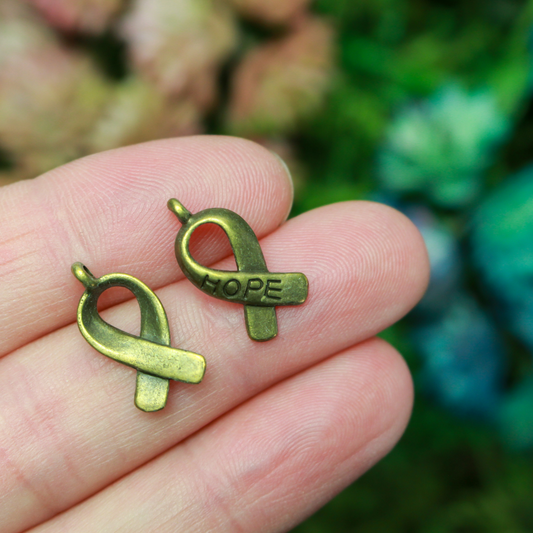 Bronze awareness ribbon charms with the word "HOPE" engraved on the ribbon, 18mm long