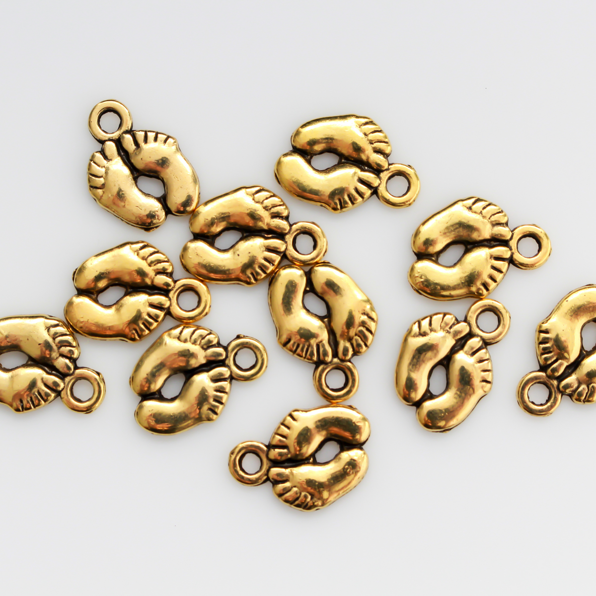 Gold baby feet charms for jewelry marking or craft projects, 14mm long