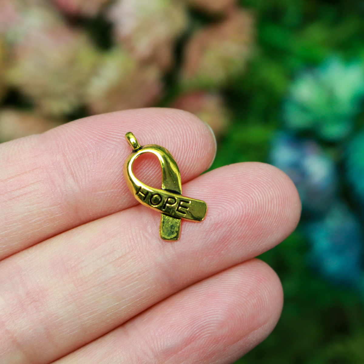 Gold awareness ribbon charms with the word "HOPE" engraved on the ribbon, 18mm long
